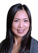Maria Trinh, PA-C, smiling, with long dark hair, in a grey top