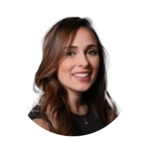 Dr. Yasmin Qaseem, smiling, with long brown hair, in a black top